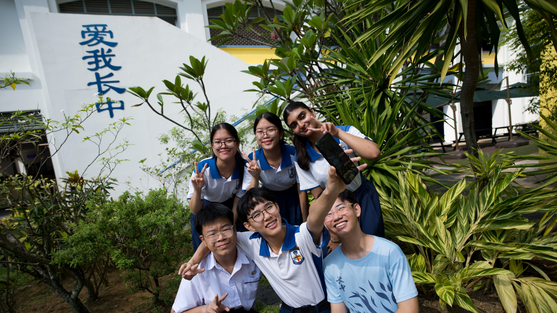 PHS students taking a wefie at the school's wall